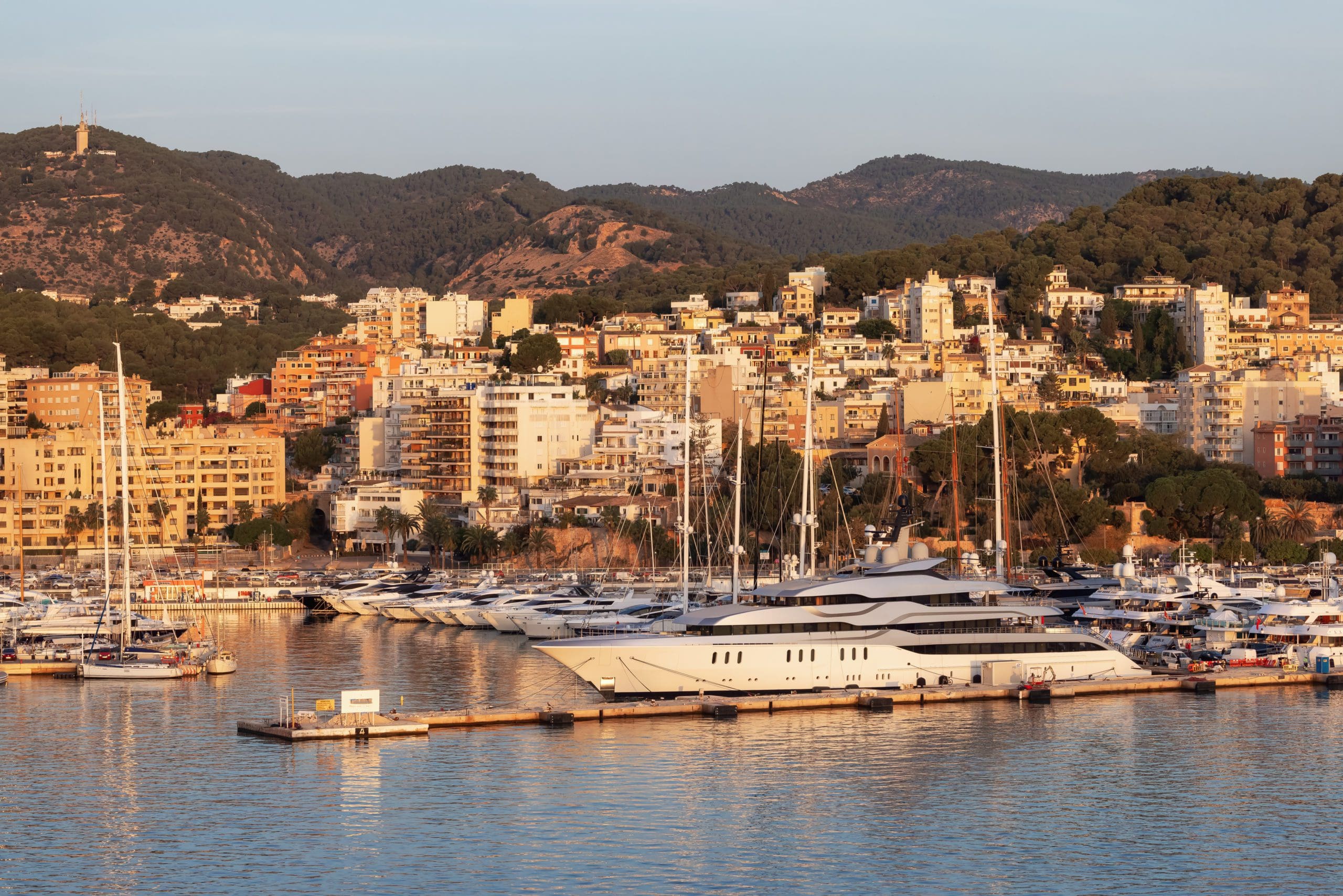 Boats in a Marina with Downtown City Buildings by Balearic Sea. Palma, Balearic Islands, Spain.